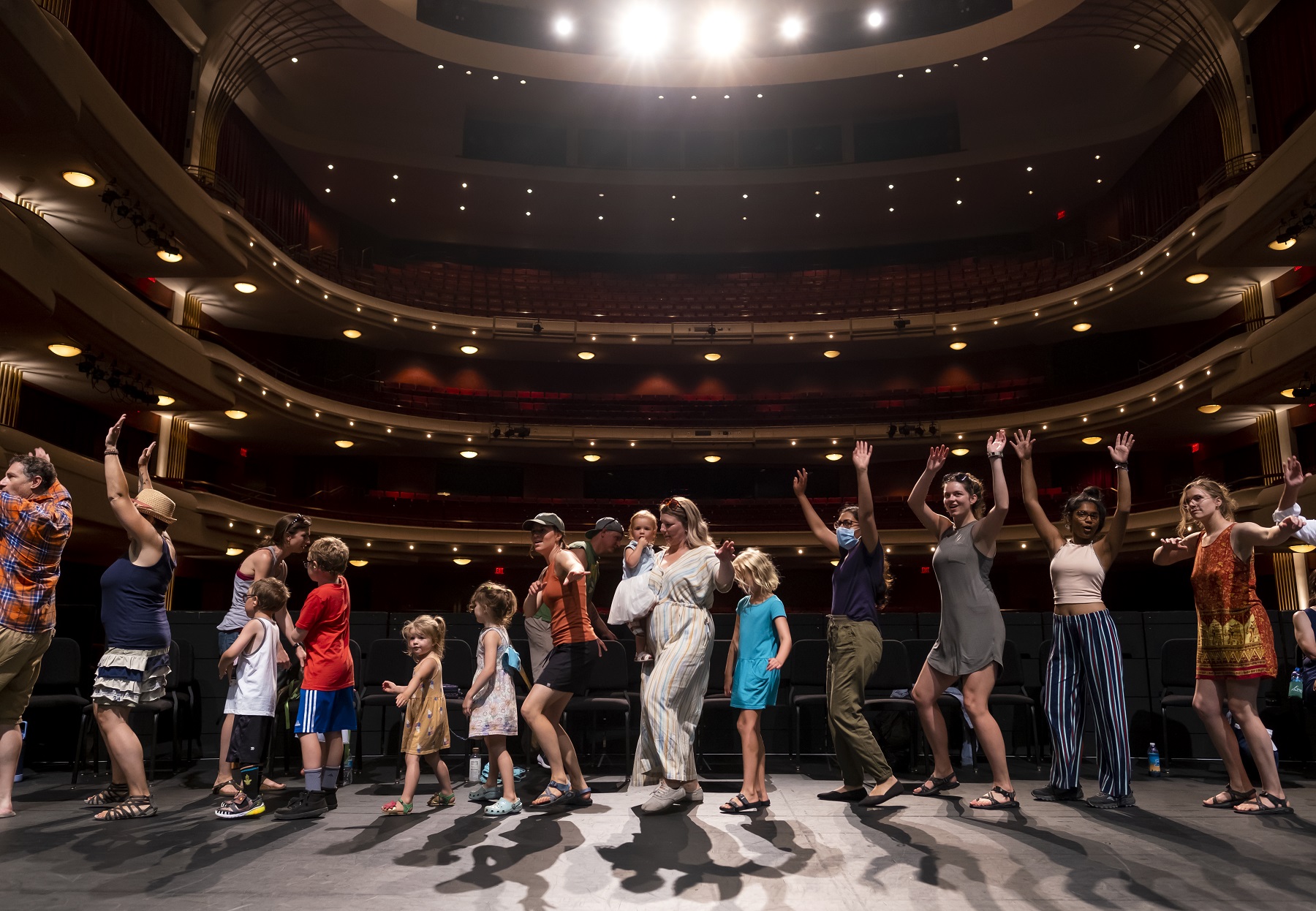 Mile of Music participants dance on stage at the Fox Cities Performing Arts Center. 