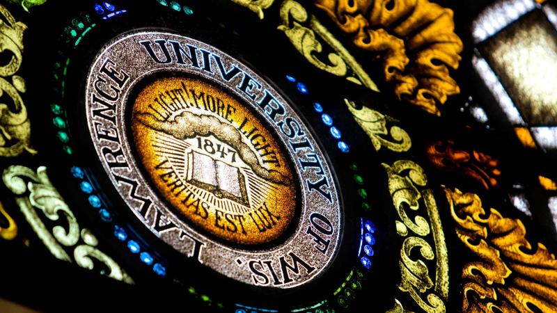 Stained Glass in Memorial Chapel. Text on glass reads, "Lawrence University, Light More Light!"