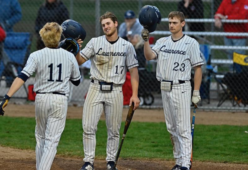 Outfield trio celebrates after home run.