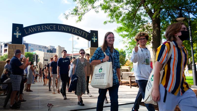 First year students walk under the Lawrence welcome arch