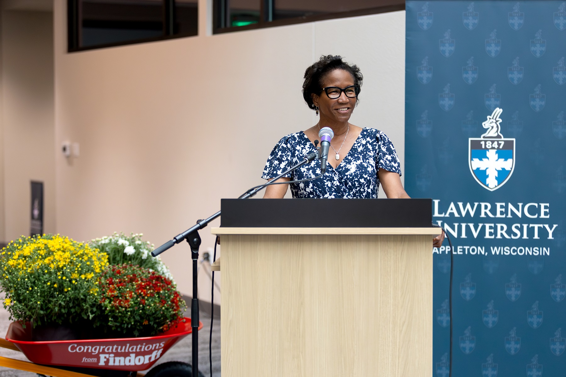 President Laurie A. Carter speaks from the podium at the Fox Commons ribbon cutting event.