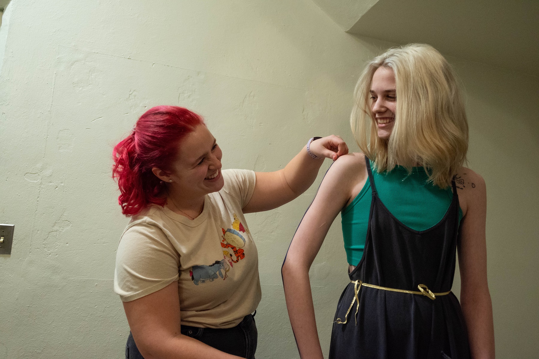 Jordan Wallin-Swanson works with sophomore Aimsley Shearer in the costume shop.