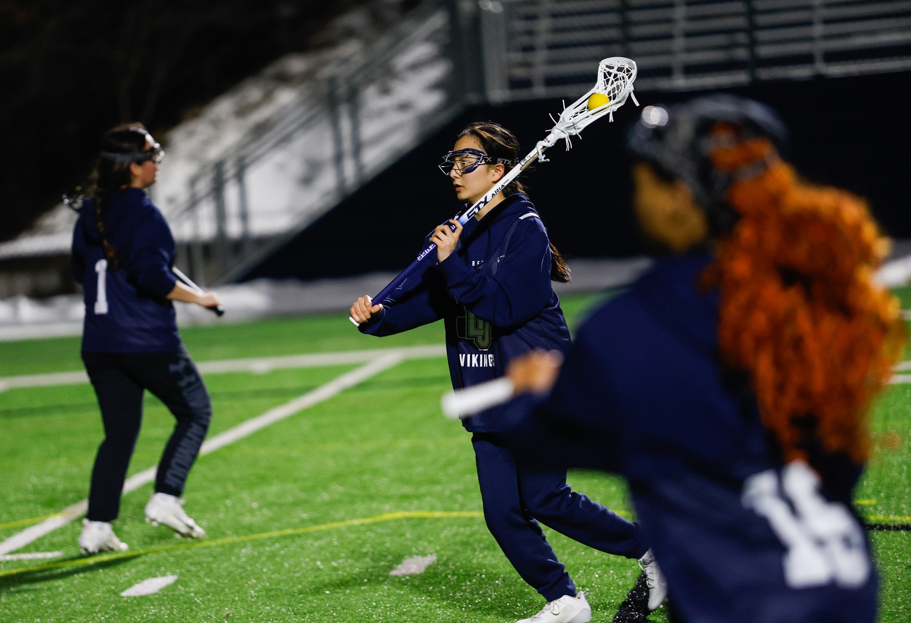 Sena Hasegawa handles the ball in practice for the women's lacrosse team. 