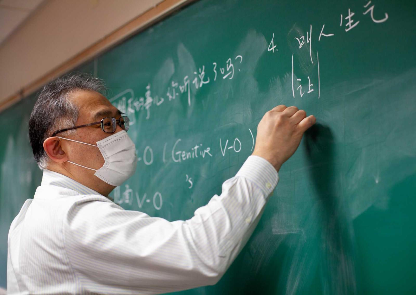 Kuo-ming Sung, Wendy and K.K. Tse Professor of East Asian Studies, writes on blackboard during Intermediate Chinese