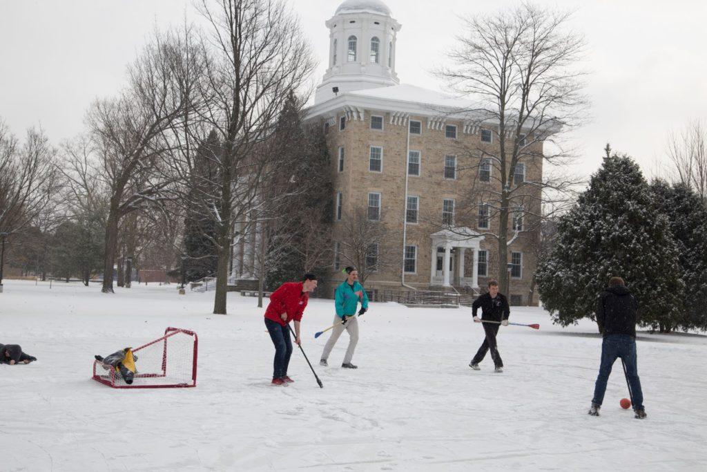 Students playing hockey on Ormsby lake