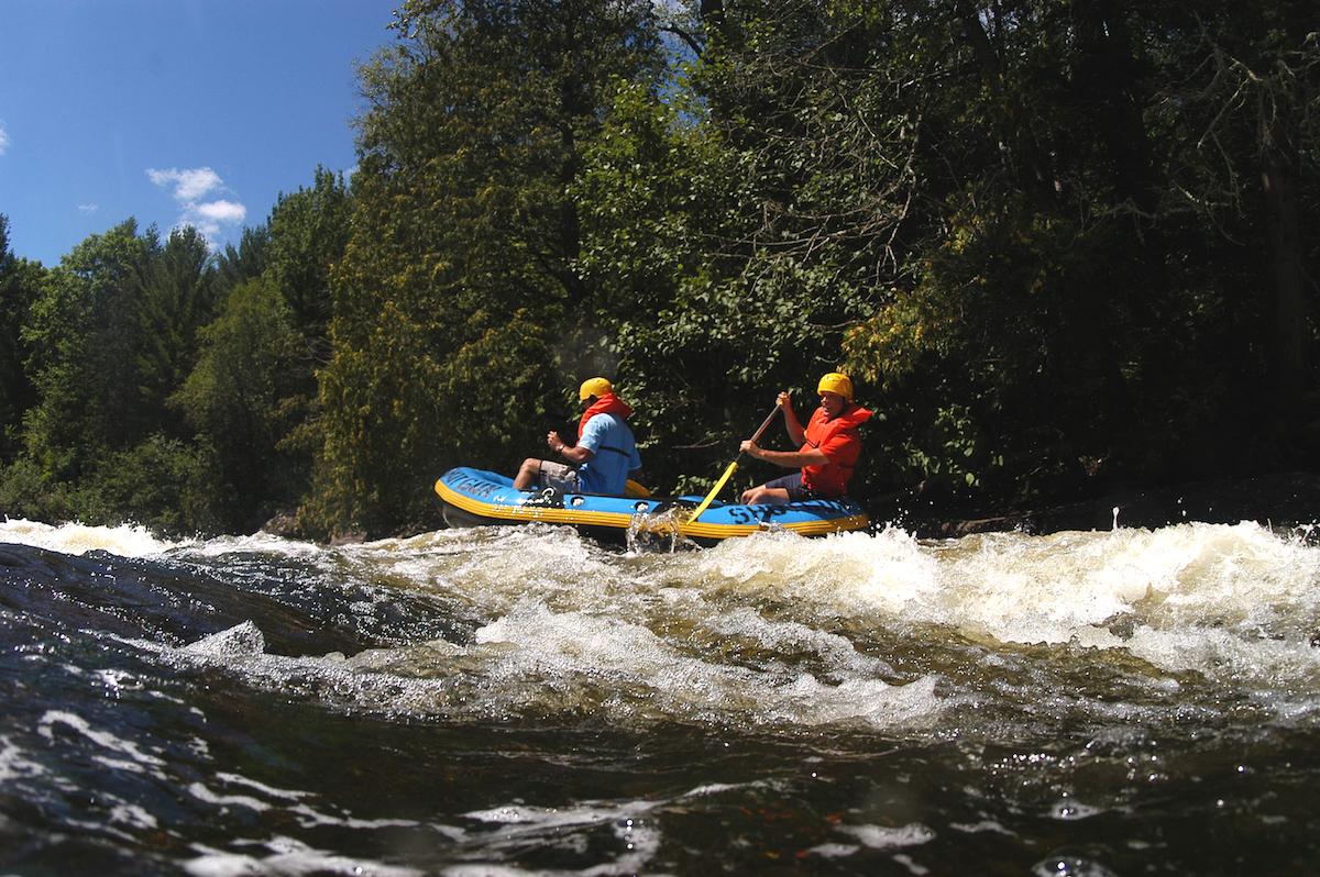 two people whitewater rafting on Wolf River