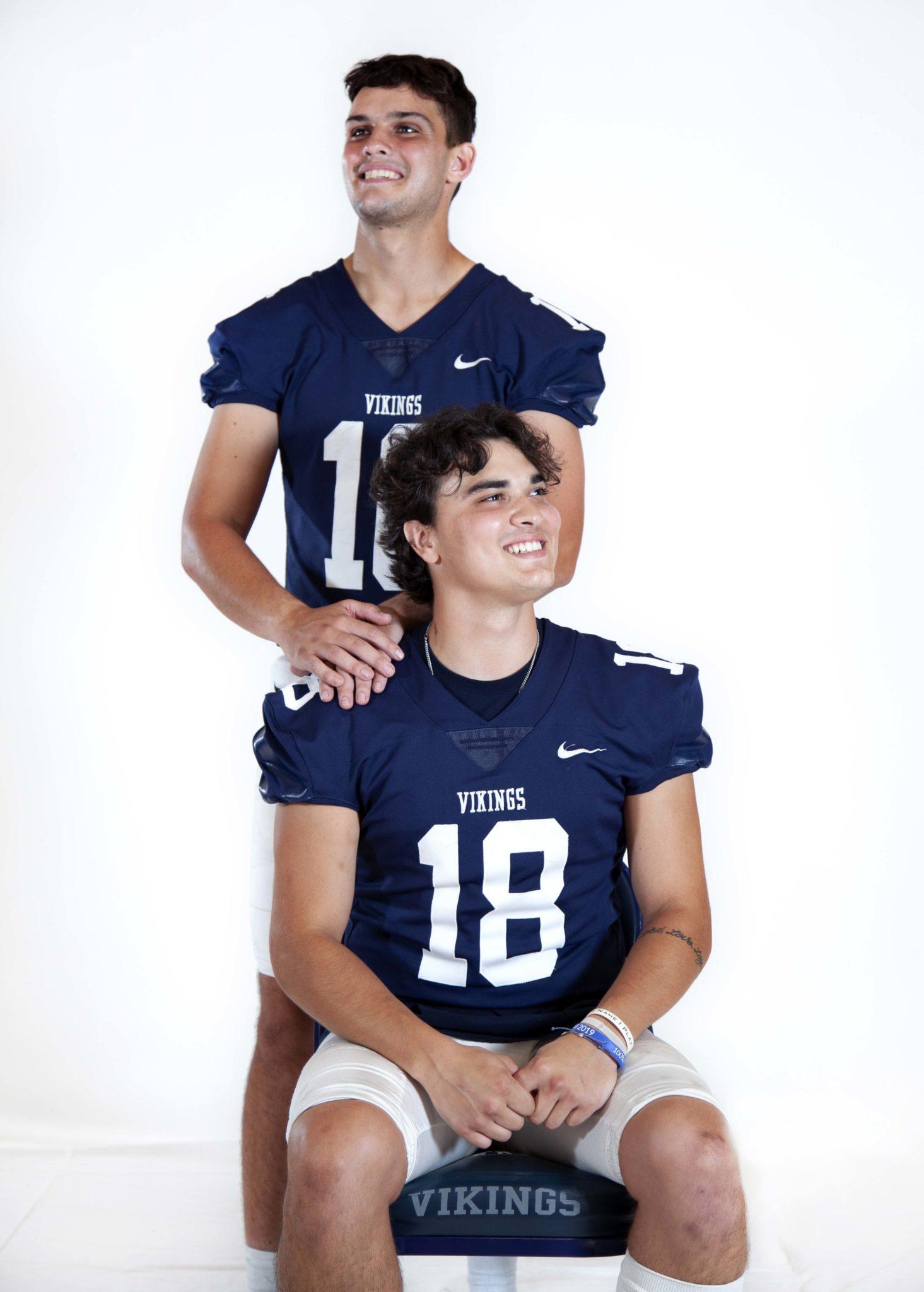 Football players Billy Wallisch and Nick Pastrone look off in opposite directions