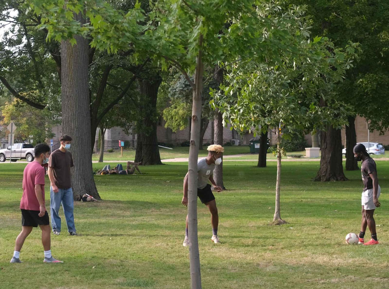 Group of students playing soccer on Main Hall Green.