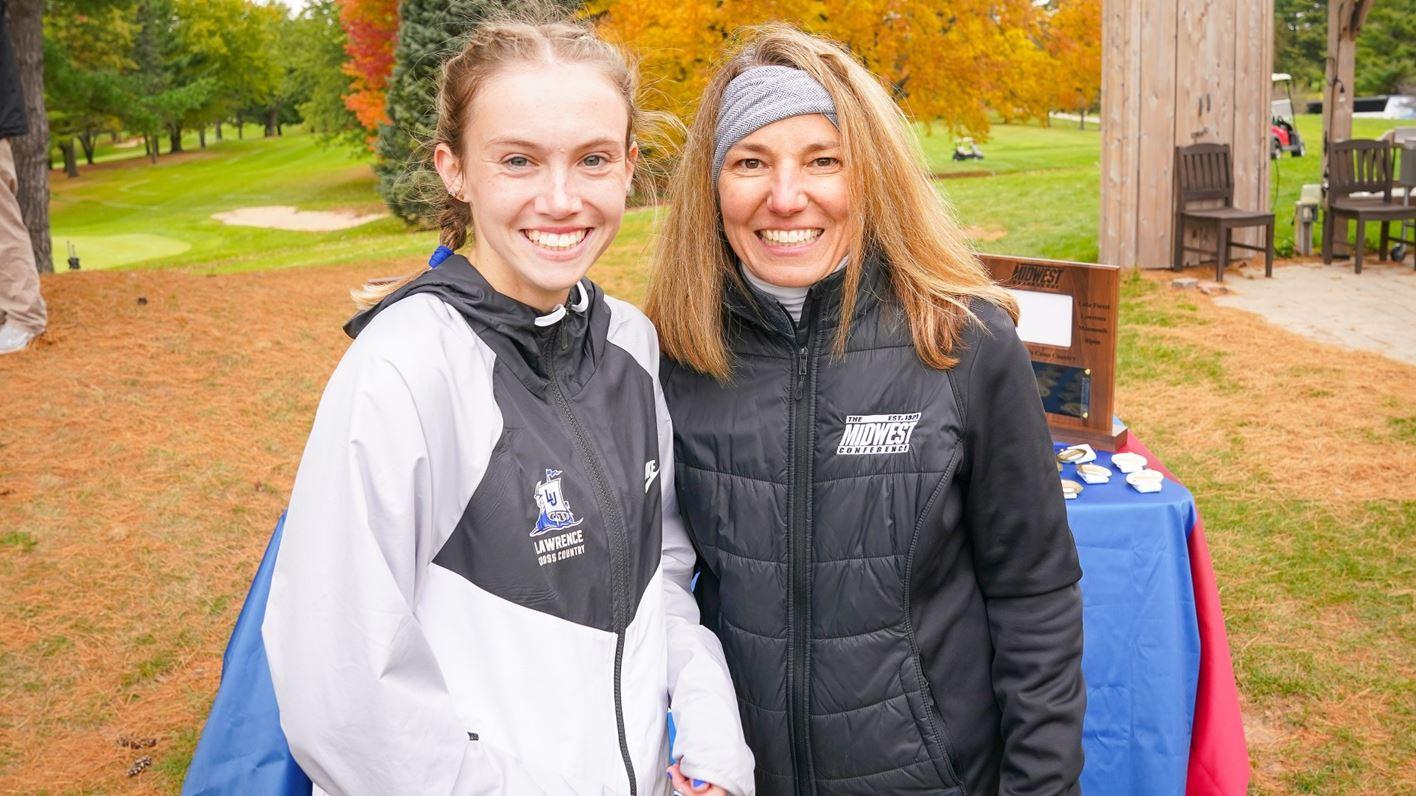 Cristyn Oliver poses with Midwest Conference Director Heather Benning following her winning run Saturday in Green Lake.