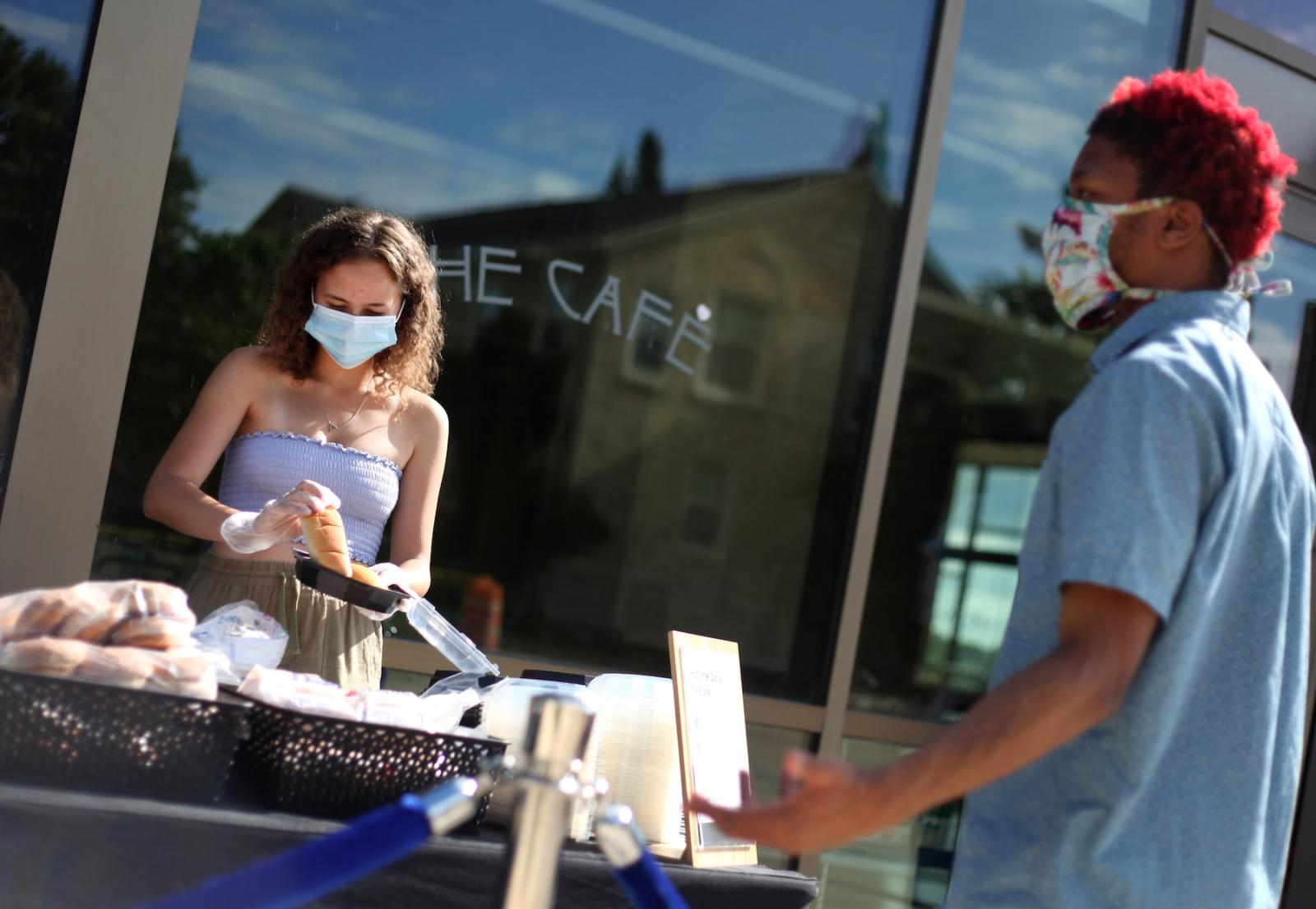 Student serving another student good during an event on campus.