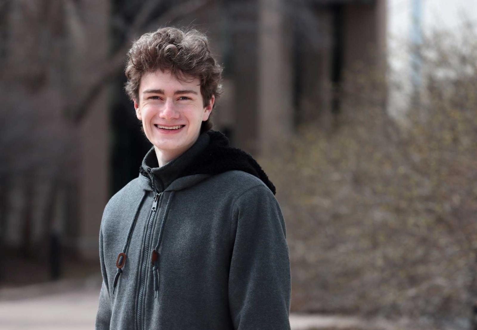 Travis Dillon poses for a portrait on the Lawrence campus.