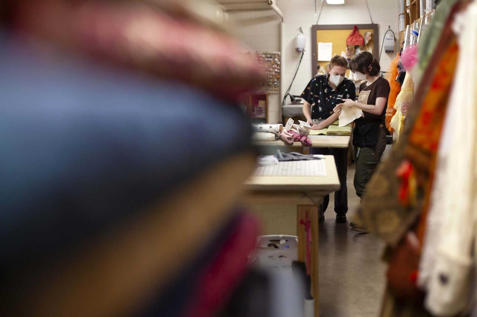 Maeve Shaffer, a junior, and Maeve Shampine, a sophomore, work on costumes for Molière Inspired.