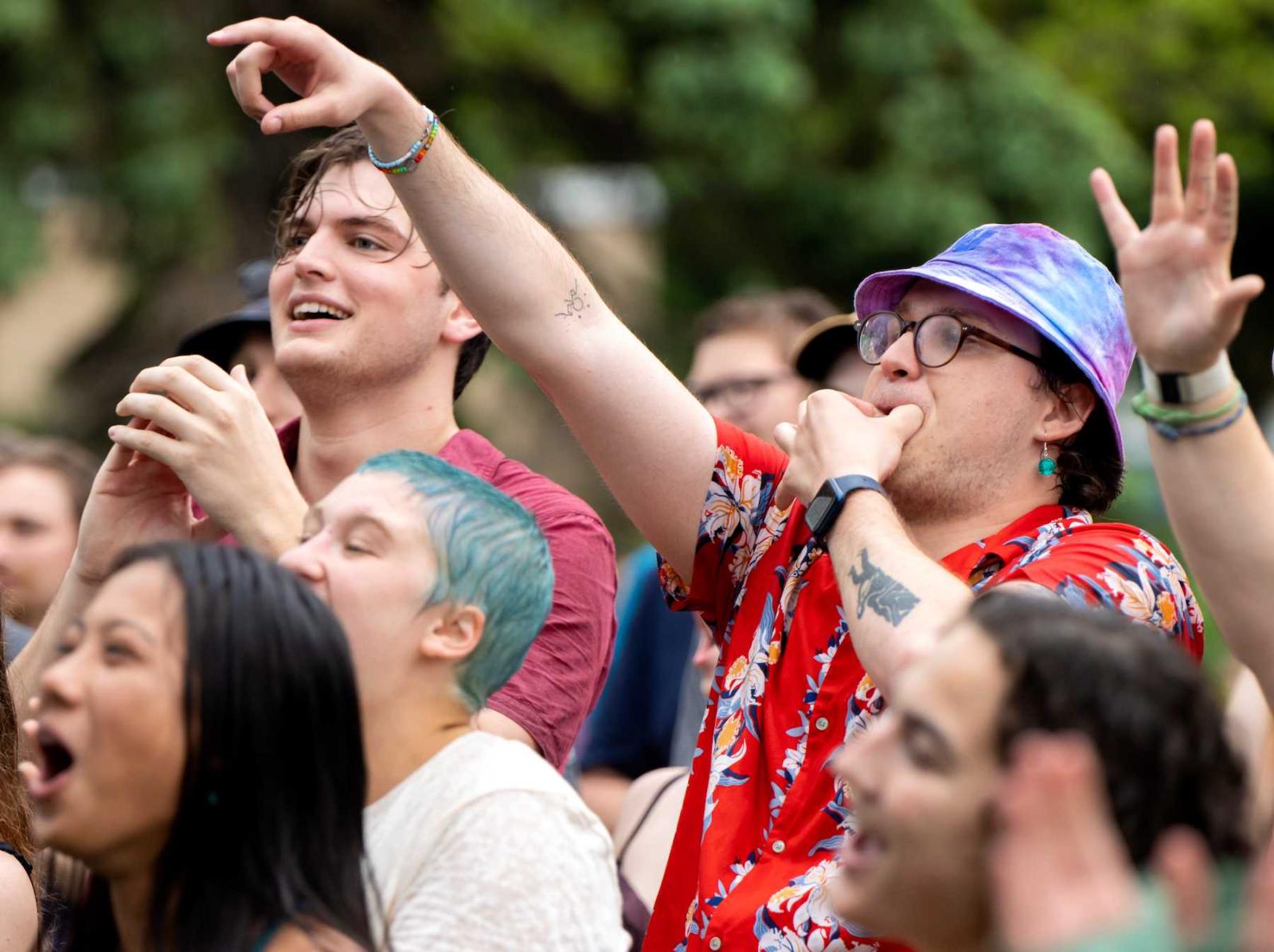 The audience shouts and applauds during an LUaroo performance.