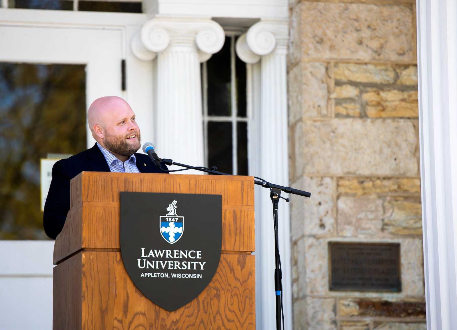 Appleton Mayor Jake Woodford speaks at the podium on the steps of Main Hall.