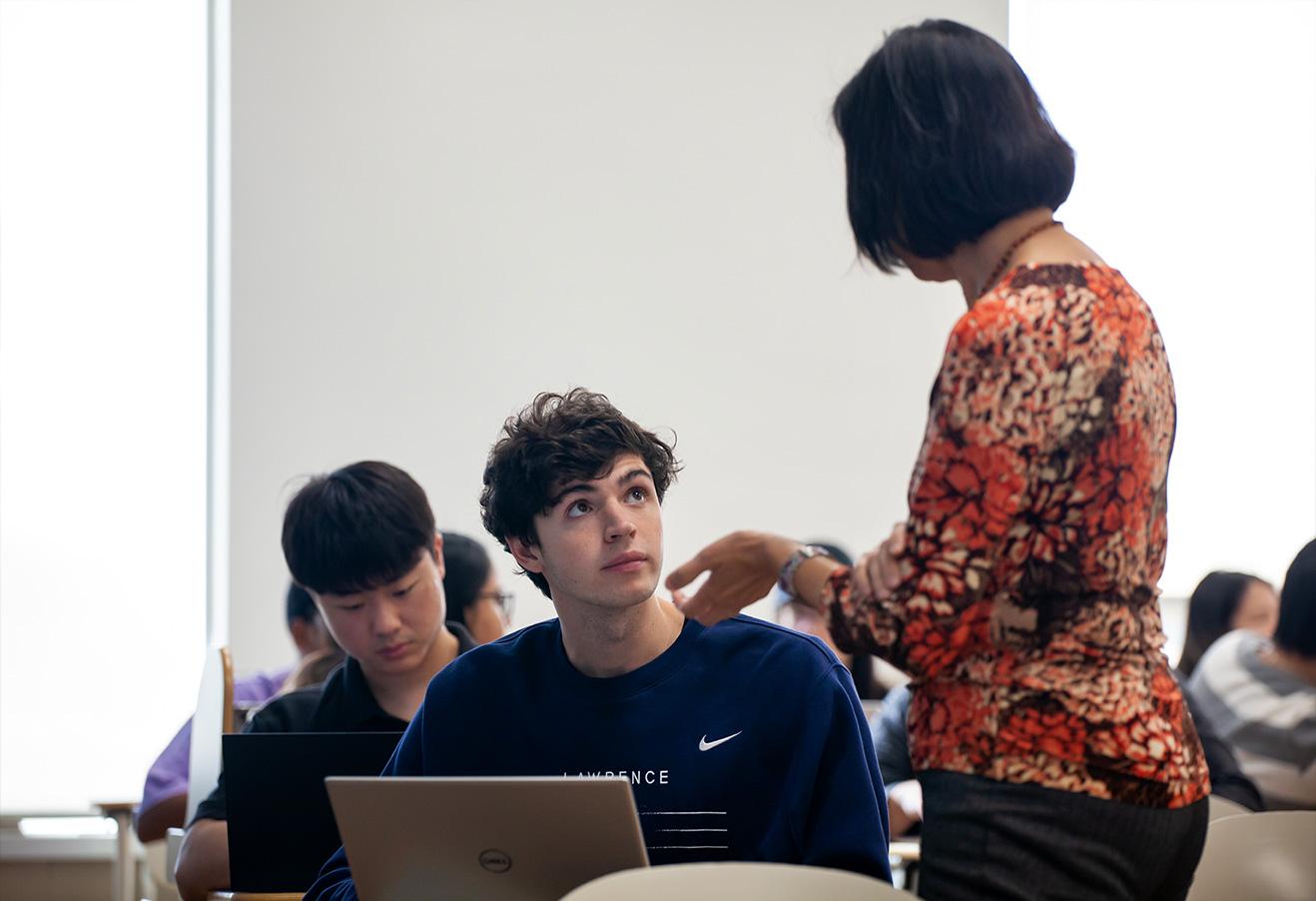 Student interacts with faculty in class