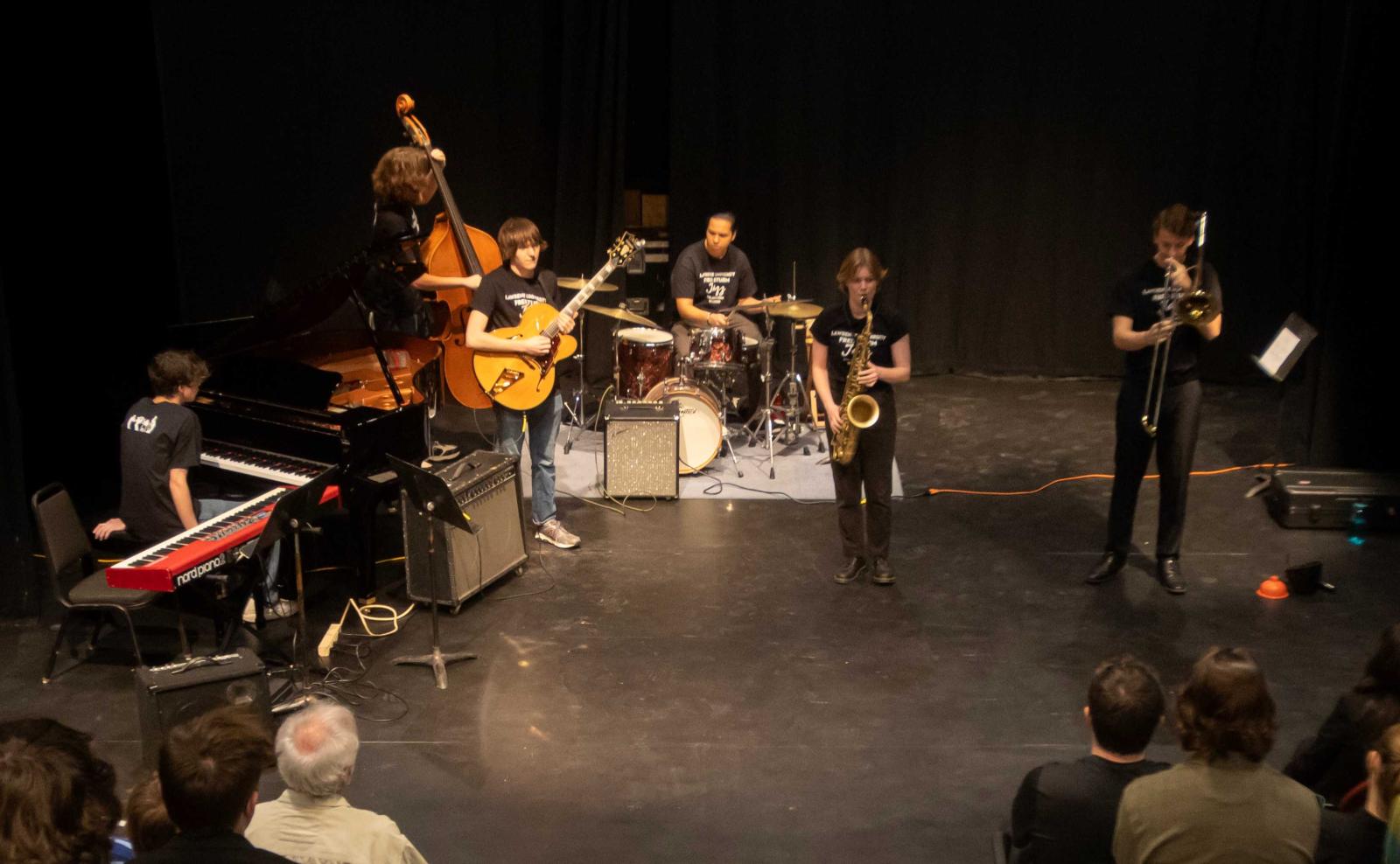 Lucy Croasdale plays the saxophone with other students during a jazz clinic in Cloak Theater.