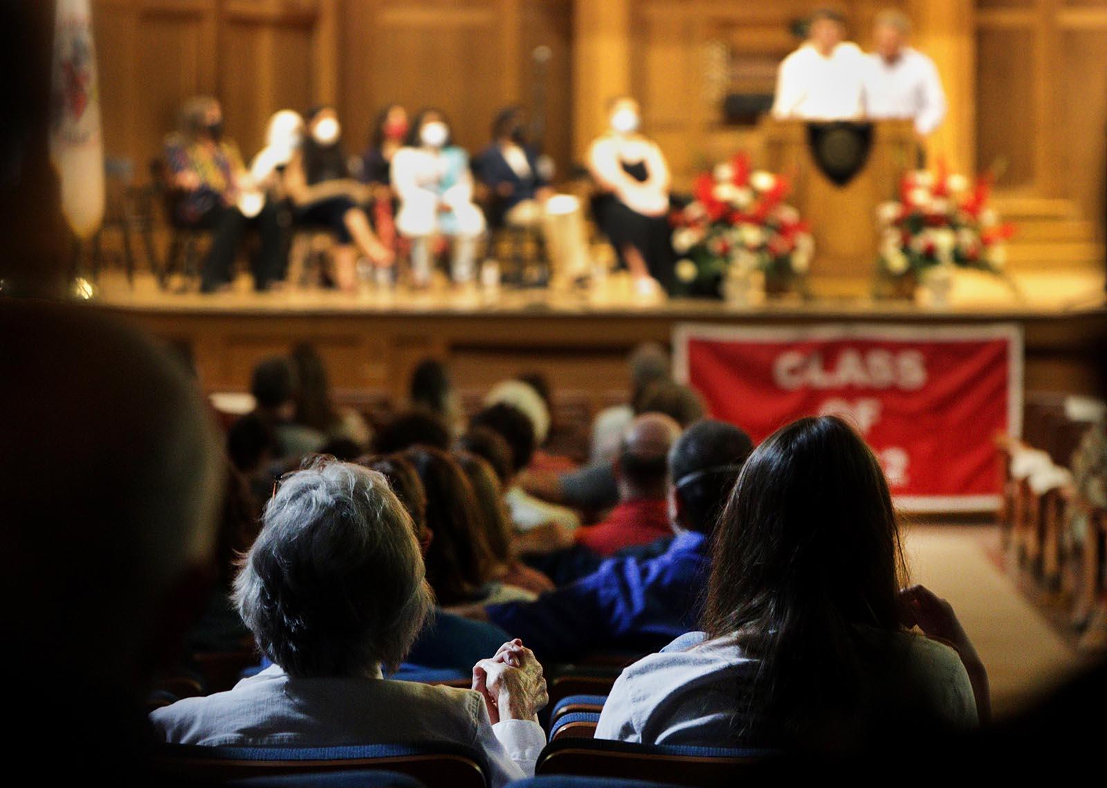 Sue Cocoma holds her granddaughter Elyssa Pfluger’s hand during the Baccalaureate Service in Memorial Chapel. 