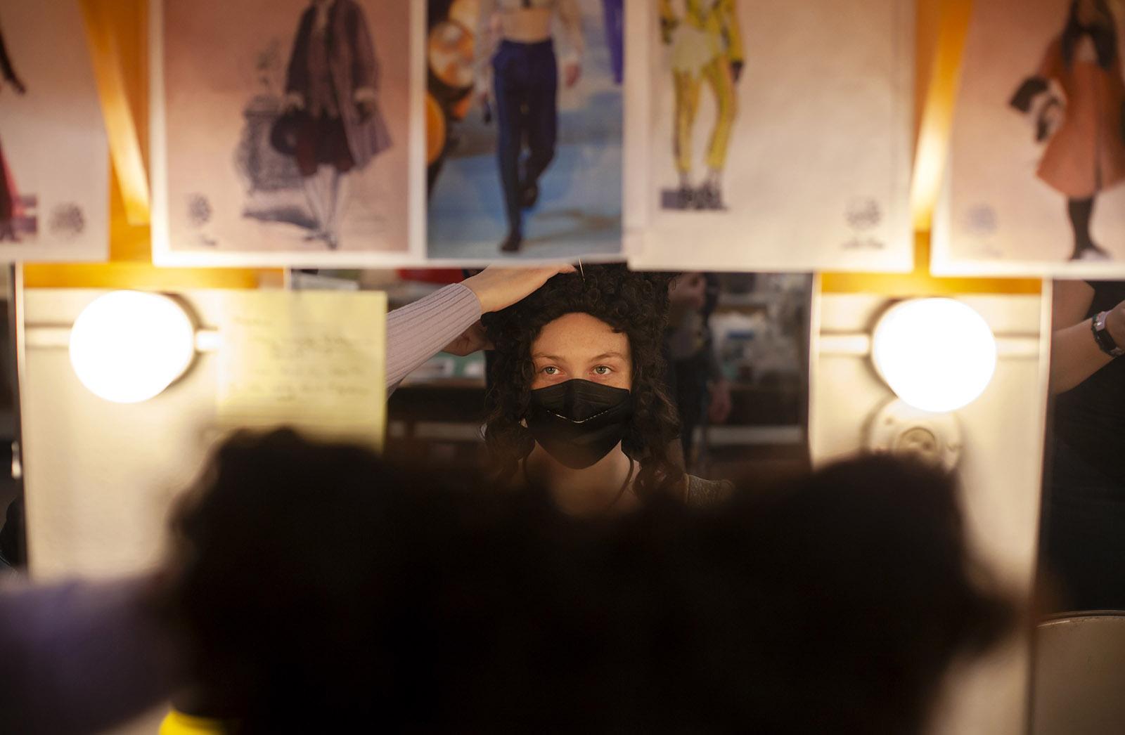 Lexi Praxl, a senior, sits in the costume shop as a wig is adjusted before rehearsal of Molière Inspired.