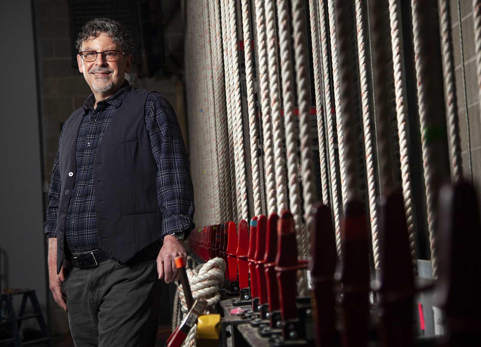 Theater professor Timothy Troy stands for a portrait in Stansbury Theater. 