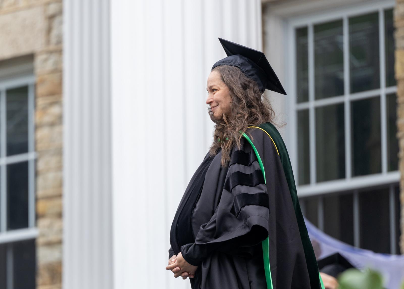 Elizabeth Sattler stands on the stage as she receives her award.