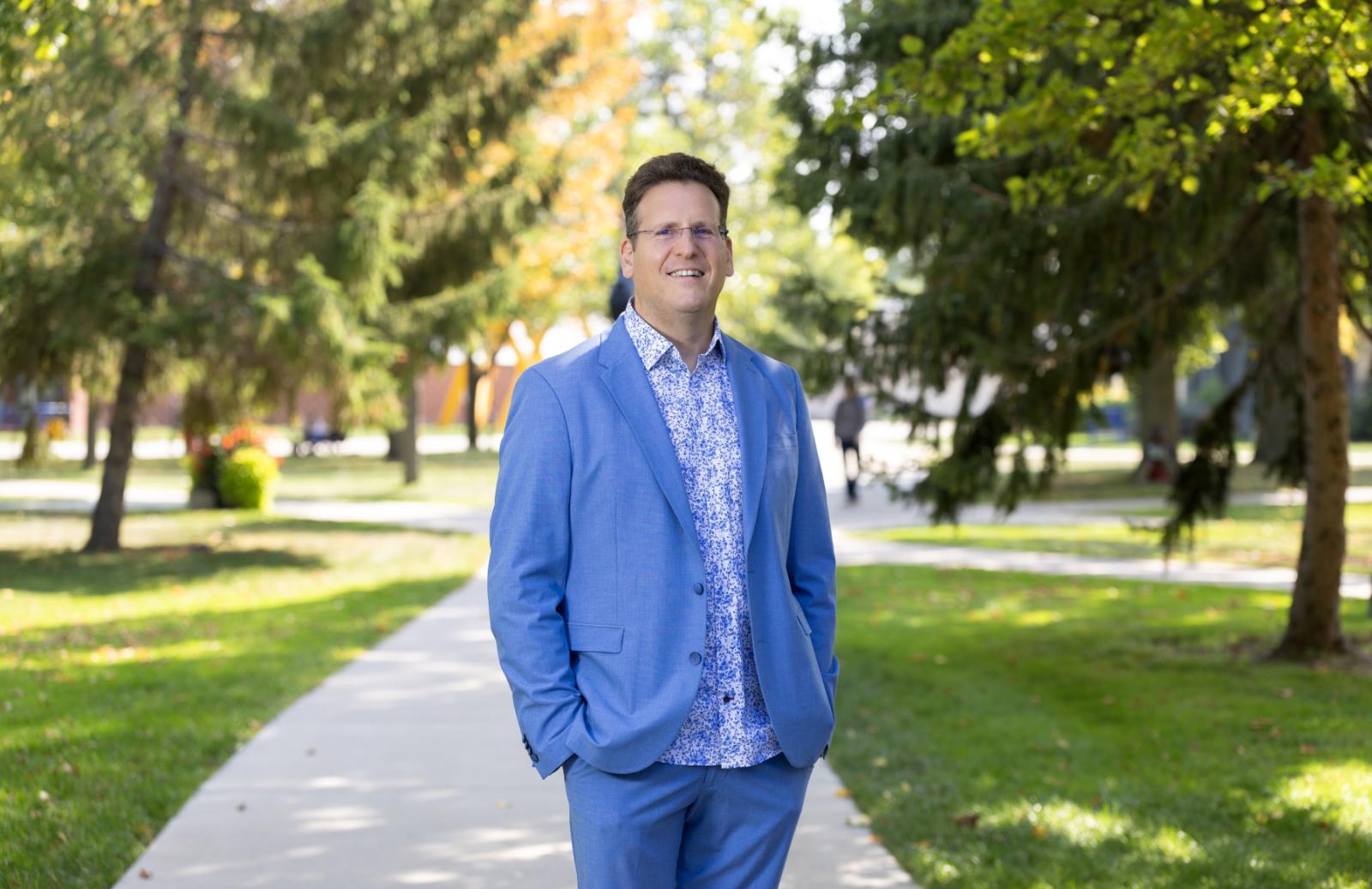 Adam Galambos poses for a portrait on Main Hall Green.