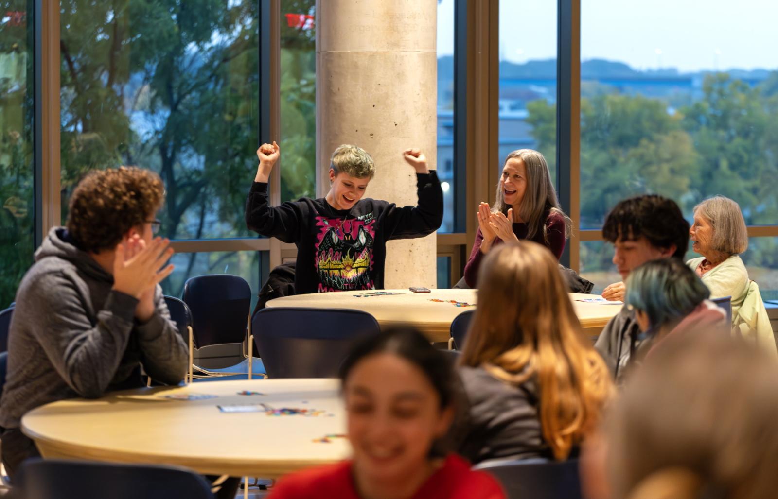 Kieran McDermott, a sophomore, celebrates with family during Bingo in Warch Campus Center, part of Blue & White Homecoming Weekend.