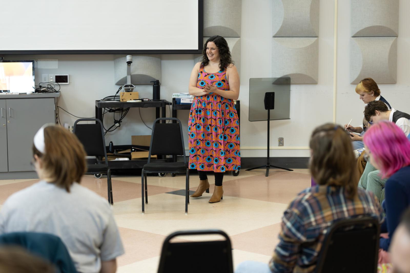 Estelí Gomez stands to speak with students in the How to Practice class in Shattuck Hall.