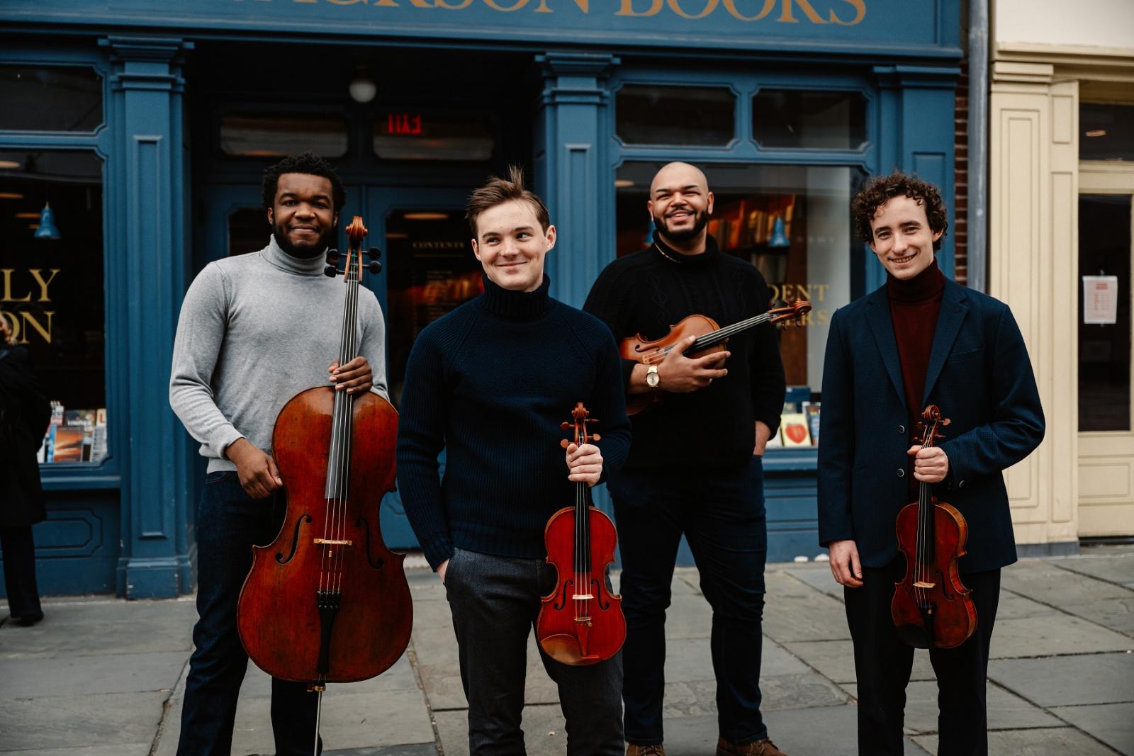 Isidore String Quartet pose for a photo.