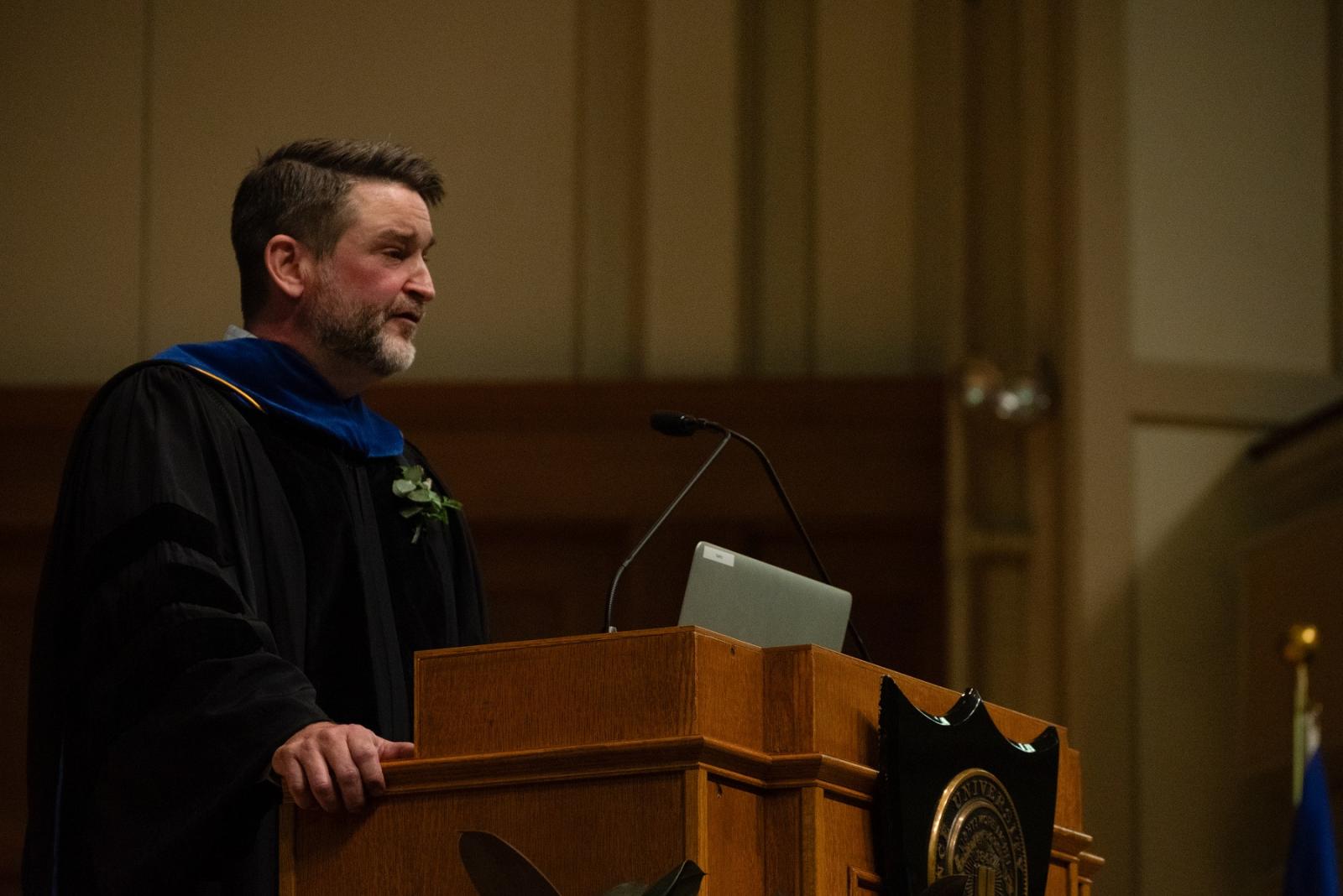 Mark Phelan delivers a lecture from the stage of Memorial Chapel during the 2024 Honors Convocation.