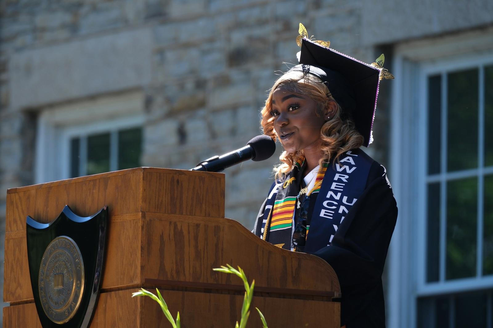 Monique Johnson '24 speaks at the podium