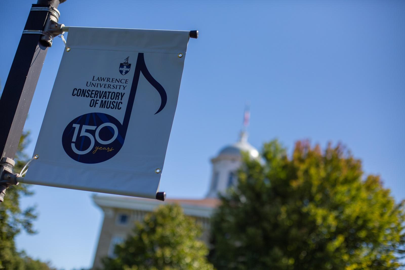 A 150 celebration banner hangs on a light pole on the Lawrence campus.