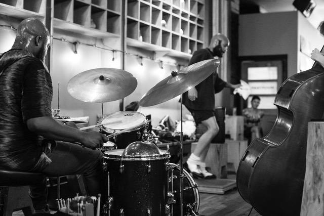 a drummer is in the foreground, with a tap dancer in the background