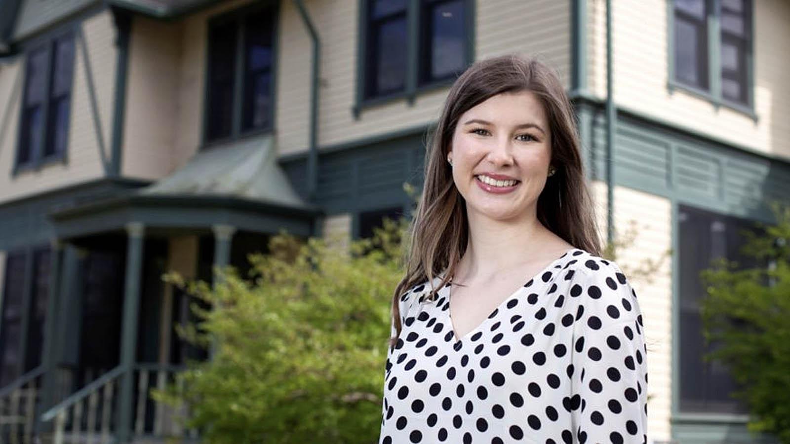 Jessica Toncler, wearing a black-and-white polka dot shirt, smiles at the camera.