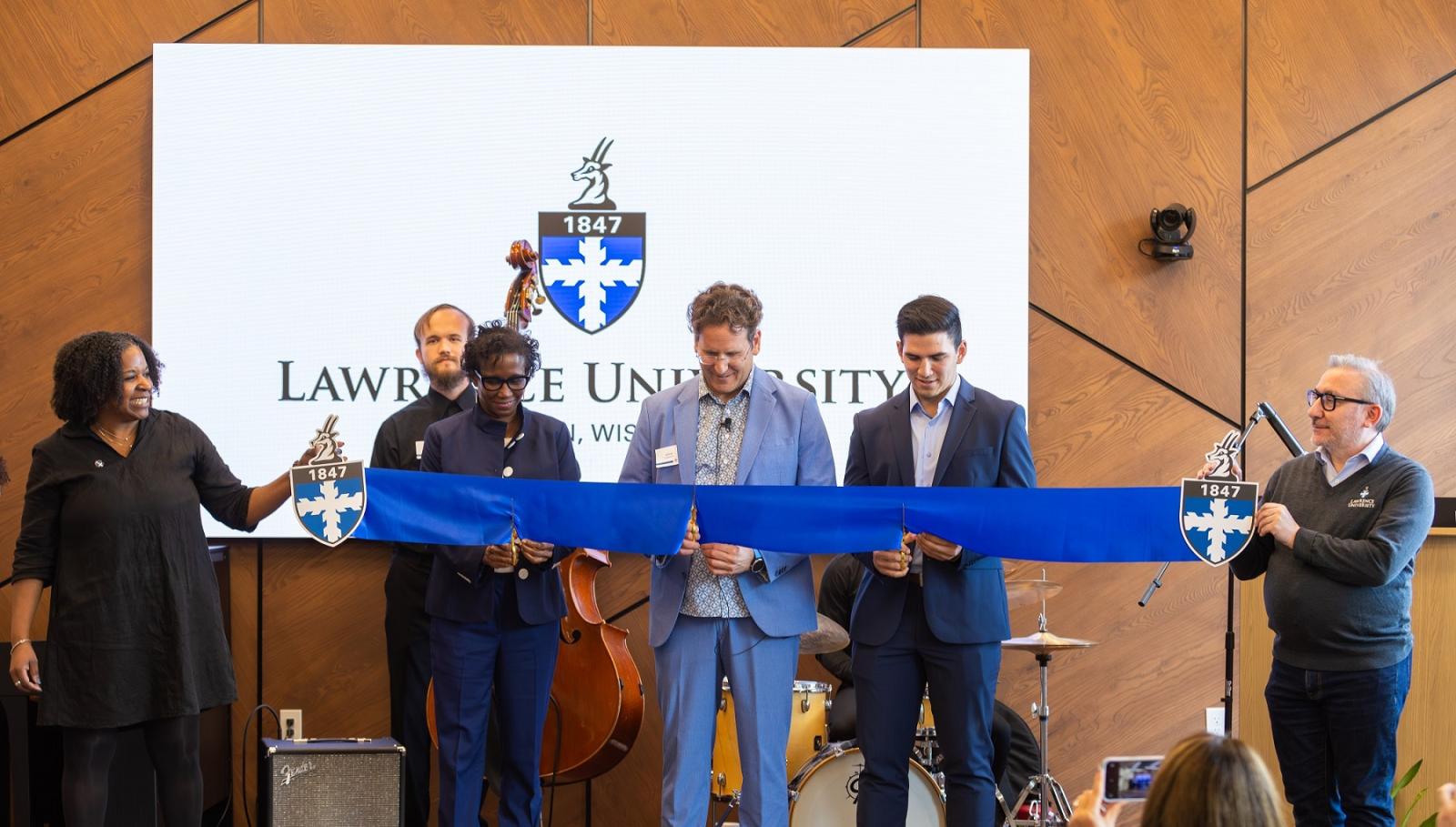 Christyn Abaray, President Laurie  Carter, Adam Galambos, Nico Manzanera, and Provost Peter Blitstein take part in a ribbon cutting in the Business & Entrepreneurship Center in Fox Commons.