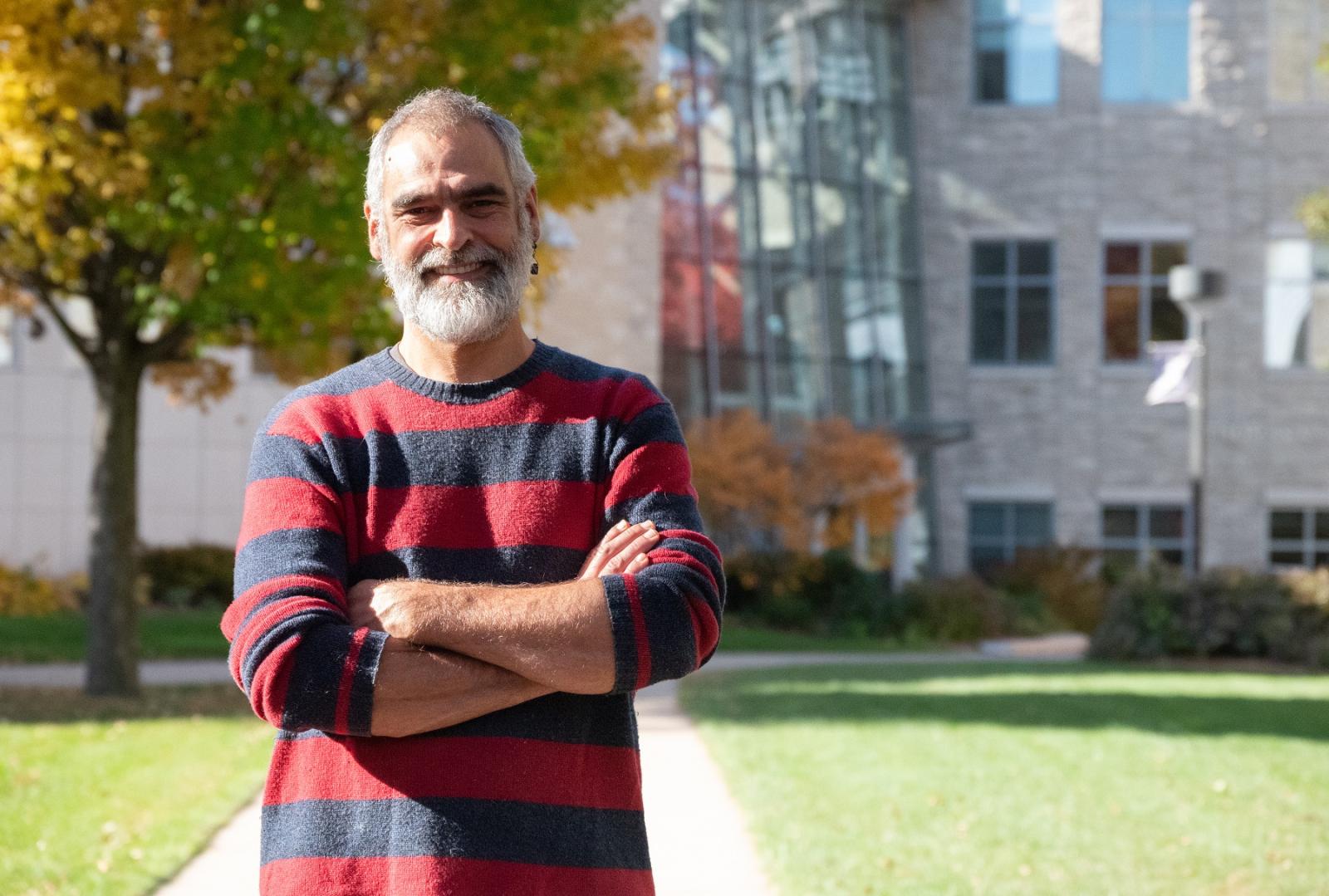 Andrew Knudsen poses for a portrait on Main Hall Green. 