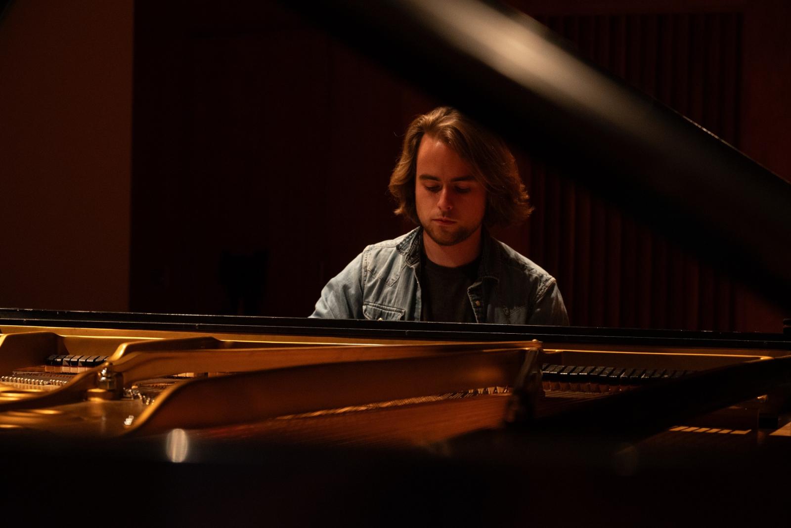 Benjamin Keating plays the piano. 