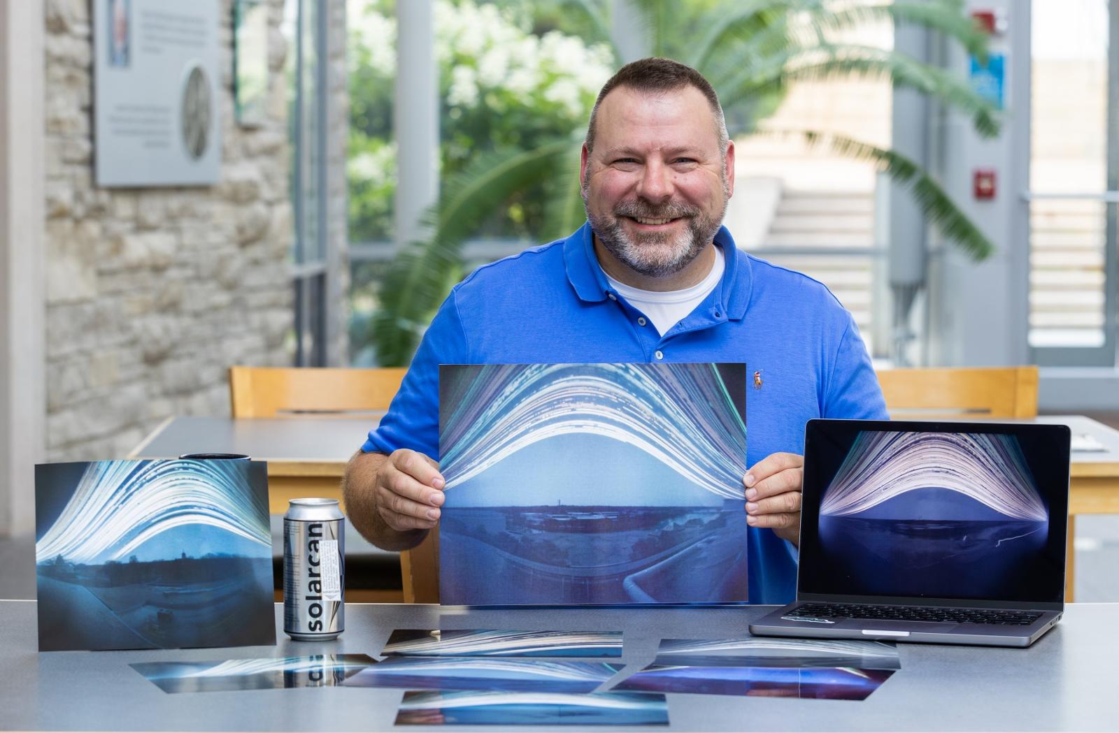 Brian Bartel ‘97 shows his Solarcan photos taken from rooftops on the Lawrence campus.