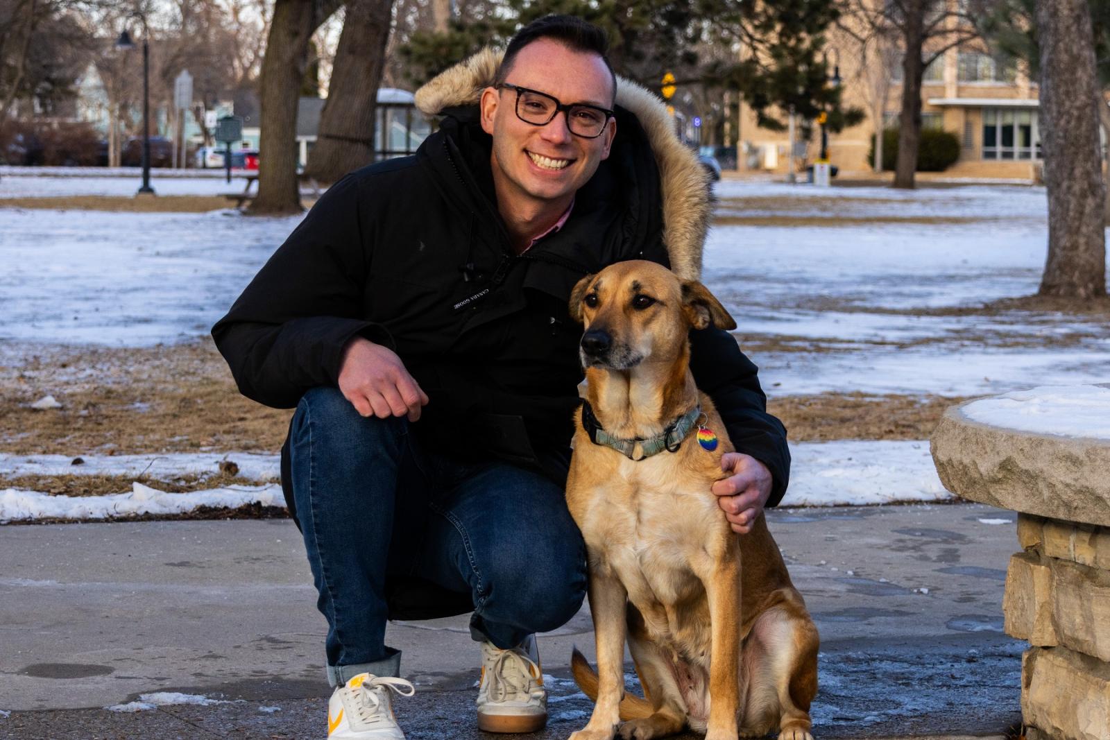 Mike Gesinski poses for a photo on Main Hall Green with his dog, Maeby.