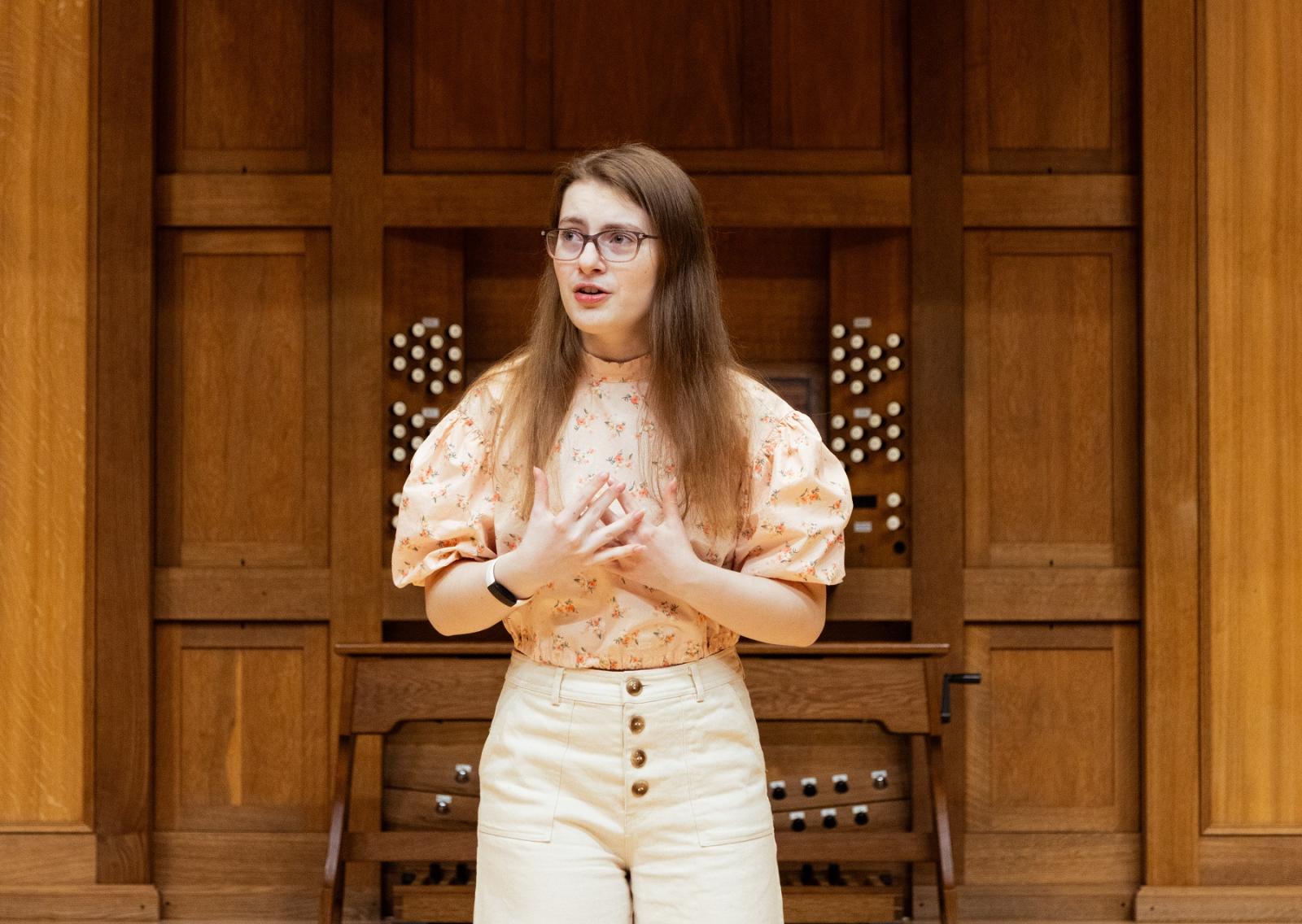 Ruby March-Torme sings on the stage of Memorial Chapel.