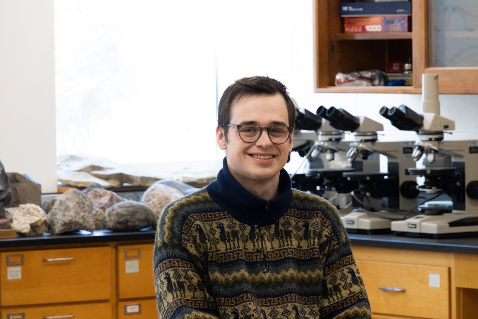 Zachary Hogan poses for a photo in a science lab at Lawrence University.