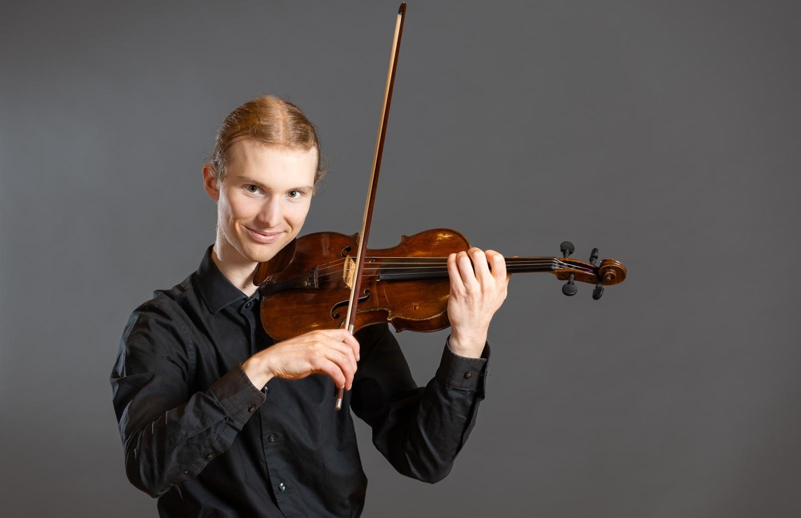 Ben Frueh poses with his violin.