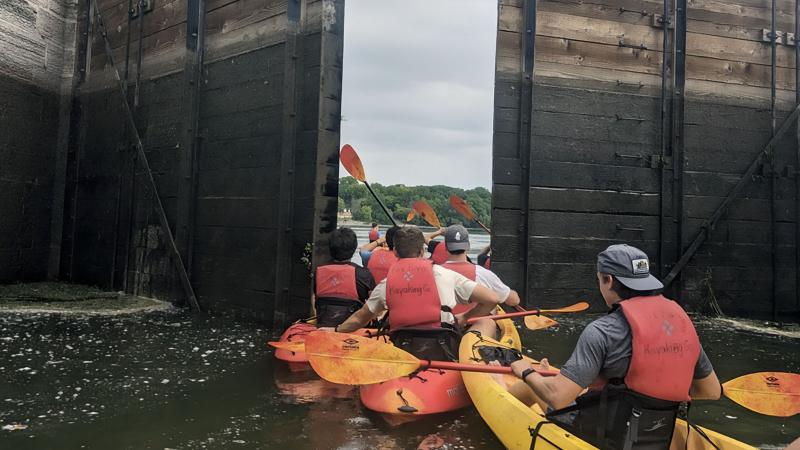 Students kayaking through Fox River locks during an Orientation Week EPIC Experience 