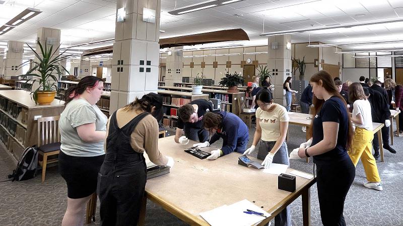 Students working on archival project in library