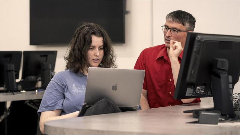 Computer science major student working on program with faculty member