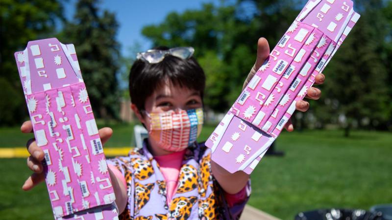 Student holding custom face masks