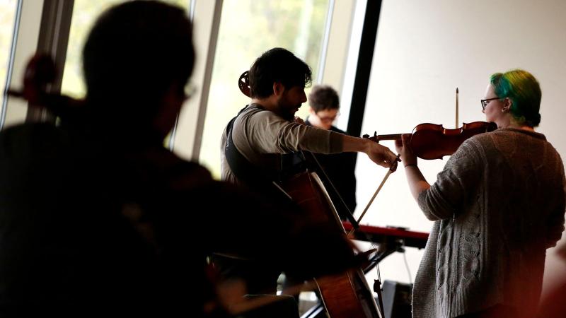 Students playing string instruments