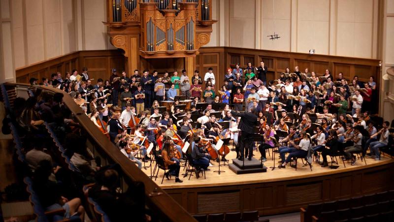 Large ensemble performs on stage