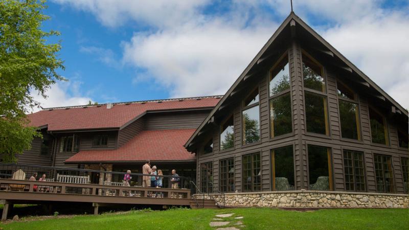 Bjorklunden patio and windowed a-frame with people on patio