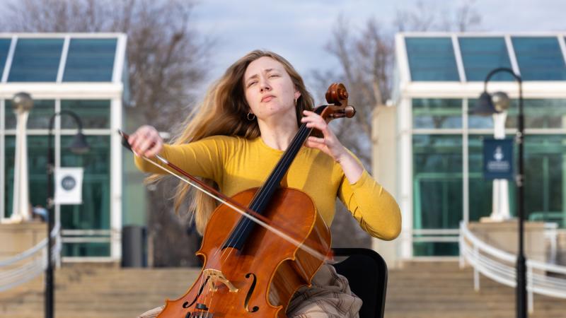 Annika Schmidt plays the cello outside of the Music-Drama Center.