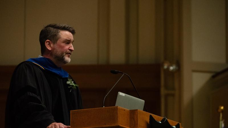 Mark Phelan delivers a lecture from the stage of Memorial Chapel during the 2024 Honors Convocation.